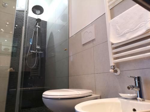 a bathroom with a shower and a toilet and a sink at Attico Barocco in Lecce