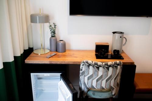 a desk with a computer and a lamp and a chair at Room Mate Cosmo - City Centre, Valencia in Valencia