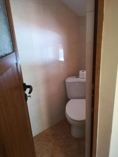 a bathroom with a toilet and a toilet paper dispenser at Villa Bulgarka in Divchovoto