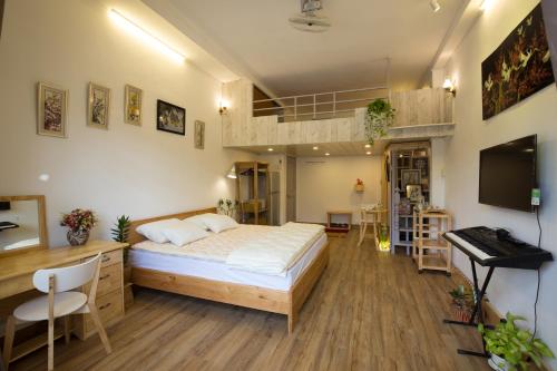 a bedroom with a bed and a desk and a keyboard at Kim Lien's Homestay in Ho Chi Minh City