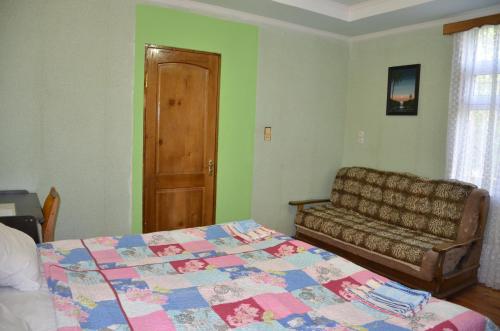 a bedroom with a bed and a couch at Friends House in Kutaisi