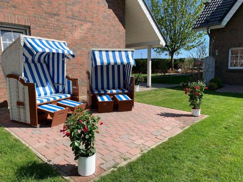two blue and white chairs sitting on a brick patio at Appartementanlage Lancken-Granitz in Lancken-Granitz
