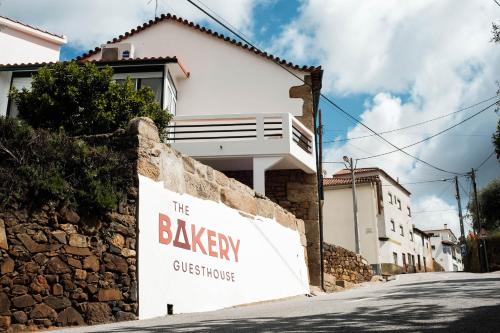 a building with a sign that reads the bakery guest house at The Bakery Guesthouse in Fundão