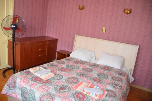 a bedroom with a bed and a fan at Friends House in Kutaisi