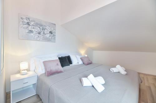 a bedroom with a bed with two crosses on it at GREY Apartment Old Town in Zadar