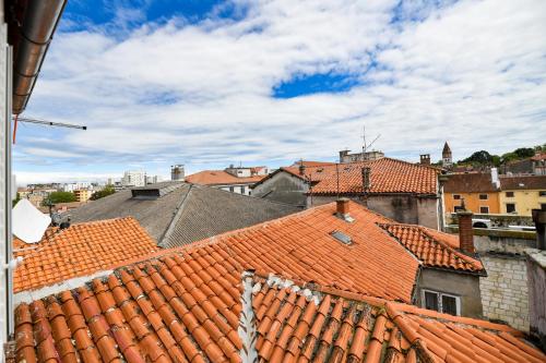 a view of roofs of a city with buildings at GREY Apartment Old Town in Zadar
