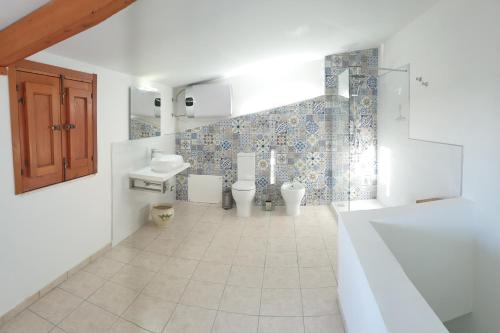 a bathroom with two toilets and a sink at A Casa Tunna in Pachino