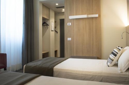 Postel nebo postele na pokoji v ubytování Hotel Alexander