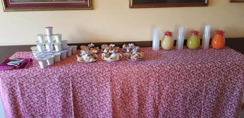 a table with a pink table cloth with stuffed animals on it at Hotel Rosy in Battipaglia