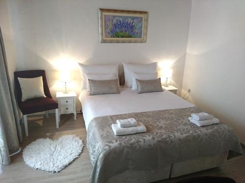 a bedroom with a bed with two towels on it at Studio Sfinga in the heart of Diocletian's palace in Split