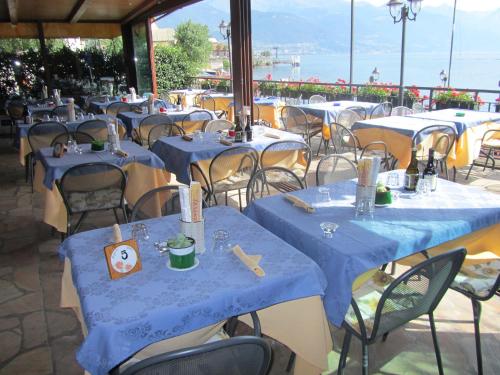a group of tables with blue table cloths on them at Residence Laguna Beach in Pianello Del Lario