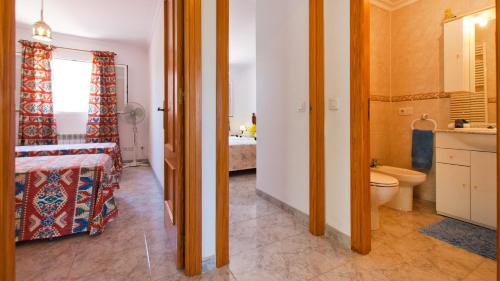 a bathroom with a bed and a toilet in a room at C237 Estrella Azul by Mallorca Villa Selection in Alcudia