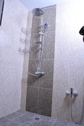 a shower with a glass door in a bathroom at Global Hotel Baku in Baku