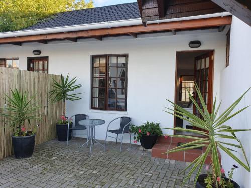 a patio of a house with chairs and a table at Outeniqua en Route in George