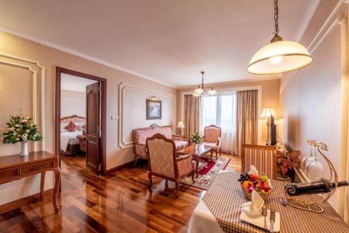 a hotel room with a living room with a living room at Hotel Grand Saigon in Ho Chi Minh City