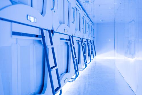a row of blue toilets in a room at Optimi Rooms Bilbao in Bilbao