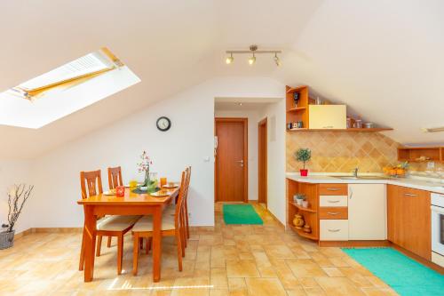 a kitchen and dining room with a table and chairs at Apartments Mondo in Mokošica