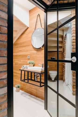 a bathroom with a sink and a toilet at Hej na Mazury Apartamenty in Ruciane-Nida