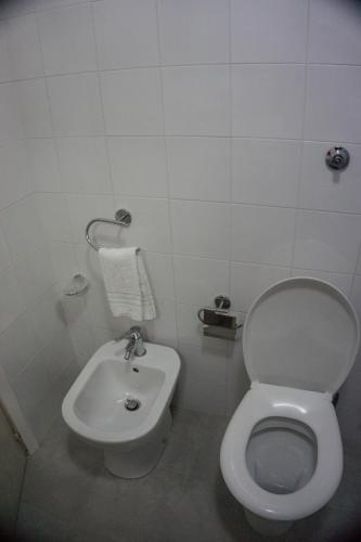 a bathroom with a toilet and a sink at Villa Moschella in Taormina