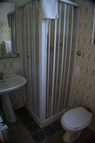 a bathroom with a shower with a toilet and a sink at Villa Moschella in Taormina