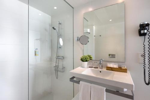 a white bathroom with a sink and a shower at HM Tropical in Playa de Palma