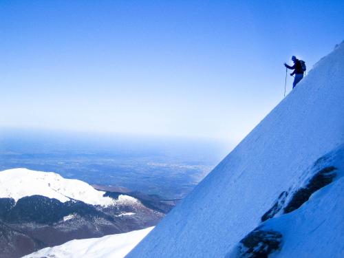a person standing on top of a snow covered mountain at Hôtel Le Montaigu in Luz-Saint-Sauveur