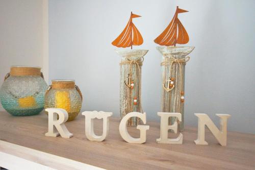 three vases sitting on a shelf with the word remix at Ferienwohnung Küstenflair in Ostseebad Sellin