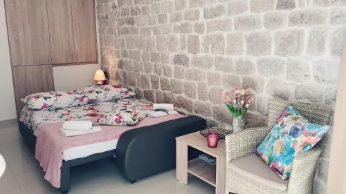a small bedroom with a bed and a table at Studio Apartment Legcevic in Kaštela