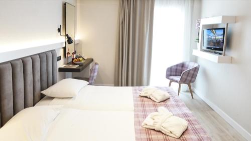 a hotel room with a bed with towels on it at Athens Cypria Hotel in Athens