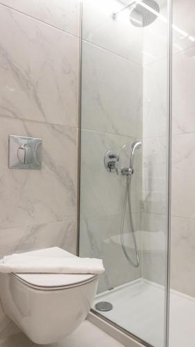 a bathroom with a toilet and a shower at Athens Cypria Hotel in Athens