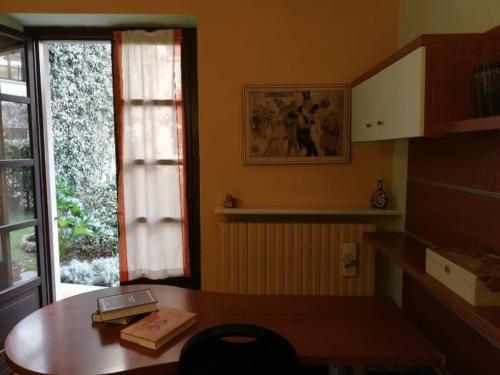 Camera con scrivania in legno e finestra. di RELAX SANTA CHIARA a Bra