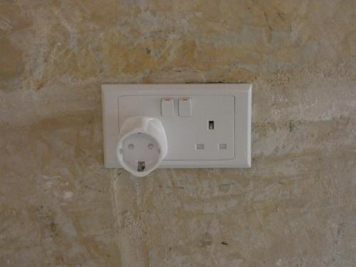 a white light switch on a stone wall at Zekka Studio in Valletta