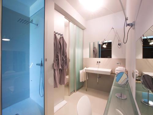 a bathroom with a glass shower and a sink at Antonello Colonna Resort & Spa in Labico