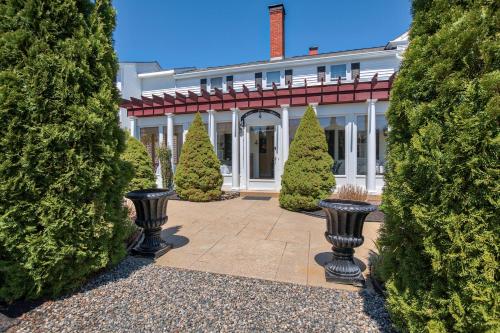 a large white house with trees in front of it at Holiday Guest House Bed & Breakfast in Wells