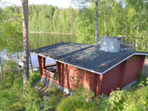 a small house sitting on the side of a lake at Holiday Home Hirviharju by Interhome in Torsansalo