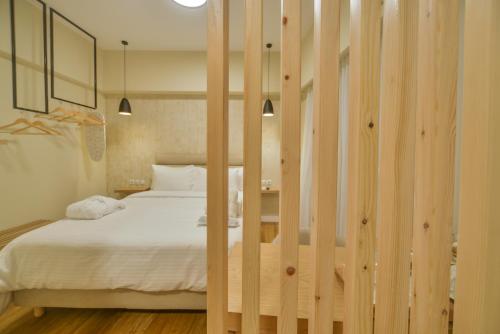 a bedroom with a bed with wooden dividers at A.P. Acropolis View Apartments in Athens