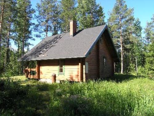 a small house in the middle of a field at Holiday Home Suvikumpu by Interhome in Tuusmäki