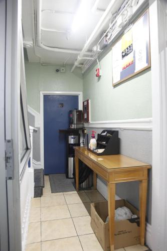 a room with a desk and a blue door at Sunnyside Hotel-Downtown San Francisco in San Francisco