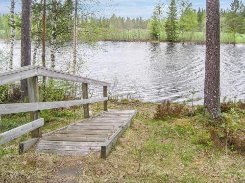 a wooden boardwalk next to a body of water at Holiday Home Yläneuvola silta by Interhome in Neuvola