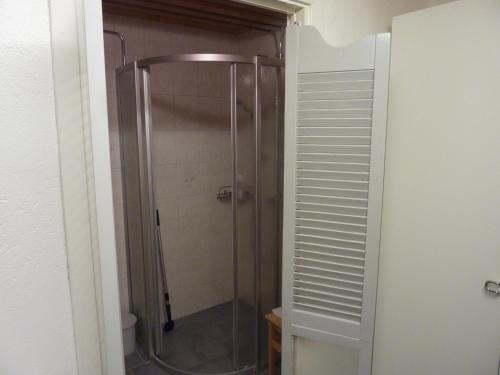 a shower with a glass door in a bathroom at Huddinge Studio with Private Entrance in Huddinge