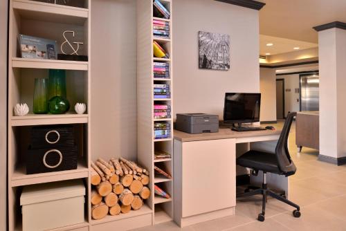 an office with a desk with a computer and a chair at Country Inn & Suites by Radisson Raleigh-Durham Airport NC in Morrisville