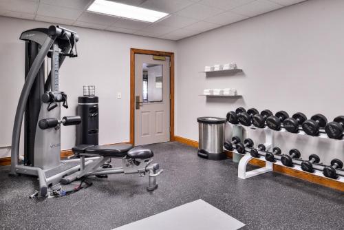 a gym with a row of dumbbells at Country Inn & Suites by Radisson Raleigh-Durham Airport NC in Morrisville