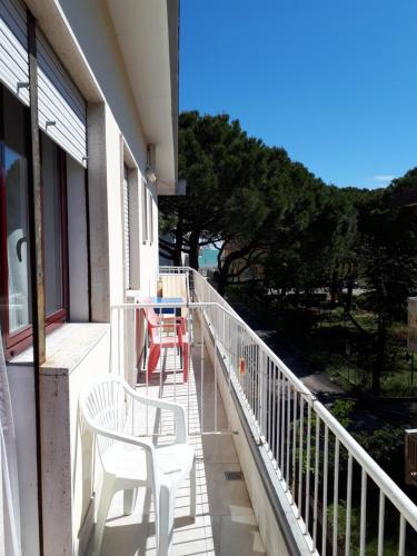 a balcony with two chairs and a table on it at Hotel Villa Dina in Lido di Jesolo