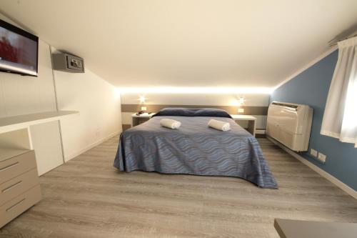Postel nebo postele na pokoji v ubytování Hotel Serenella