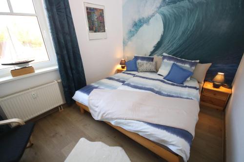 a bedroom with a large bed with blue pillows at GODS06004-FeWo-de-Klipp in Gollendorf