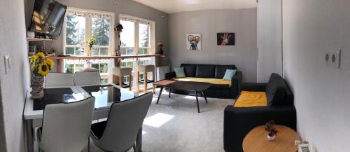 a living room with a table and a couch at Vlašić House in Vlasic