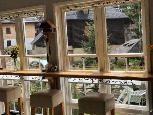 a window with four stools in a room with a view at Vlašić House in Vlasic