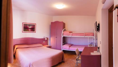 a bedroom with two bunk beds and a desk at Villa dei Mercanti in Diamante