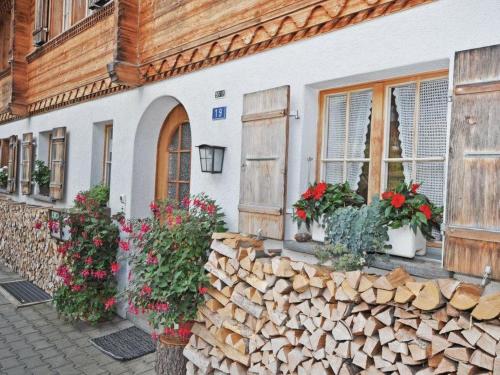 a building with flowers and plants in front of it at Apartment Chalet Bodenweg by Interhome in Frutigen
