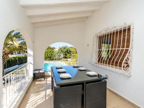 a dining room with a blue table on a balcony at Villa Aurelie by Interhome in Balcon del Mar